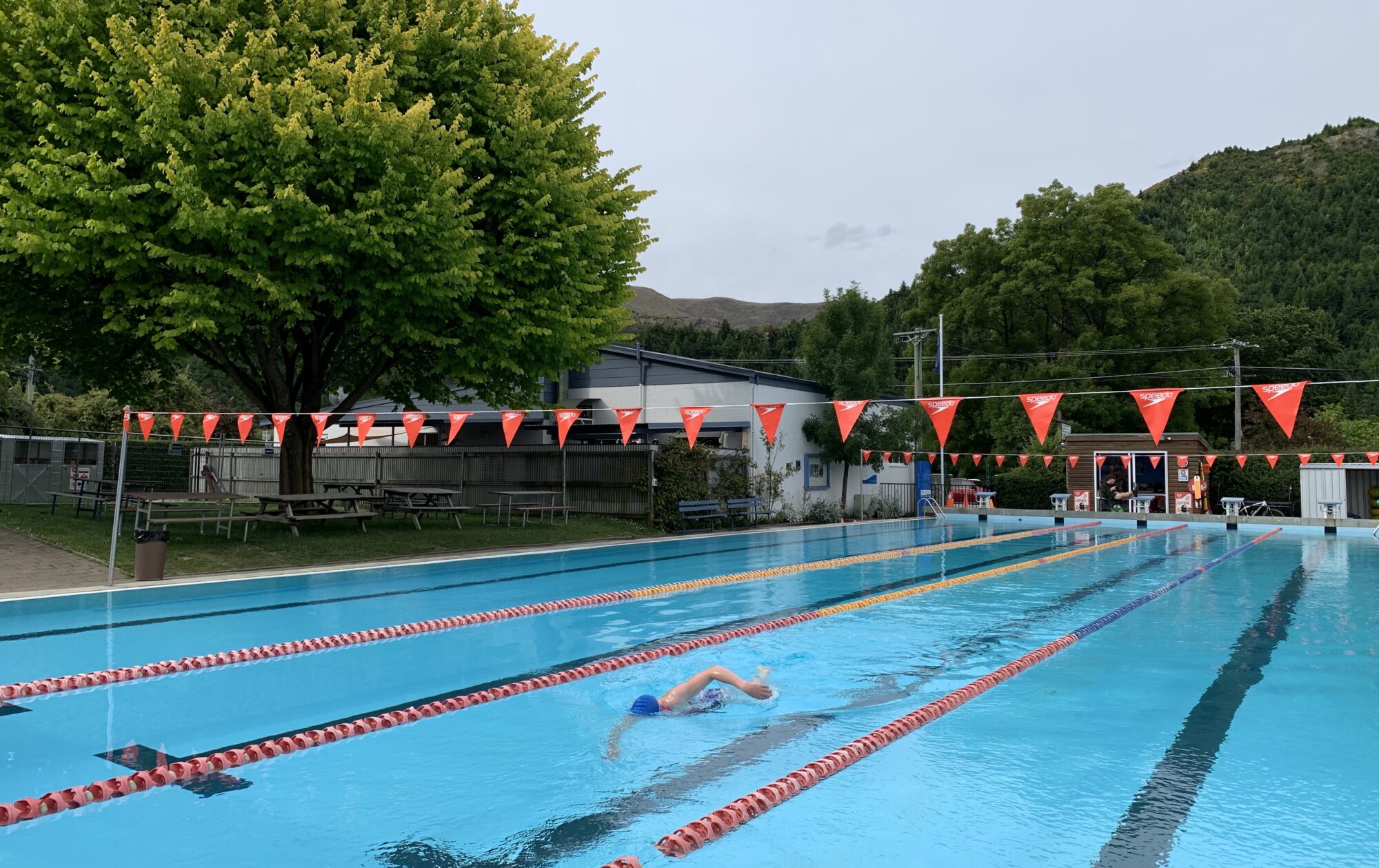 A lone swimmer does laps in the open-air Arrowtown Memorial Pool