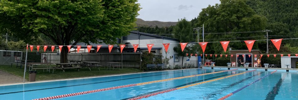 A lone swimmer does laps in the open-air Arrowtown Memorial Pool