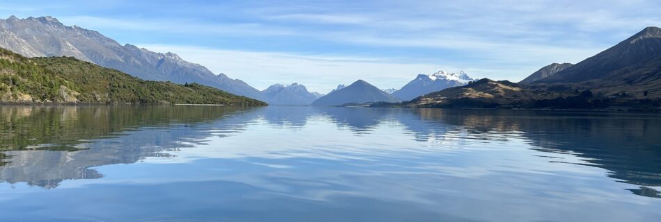 Lake Whakatipu, on the way to Pigeon Island, on a calm and sunny day, looking towards the mountains in the distance